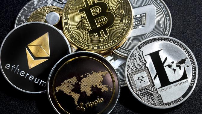 izmir, Turkey - September 28, 2018 Close up ethereum ripple litecoin bitcoin dash coins shot in metallic black background in studio.