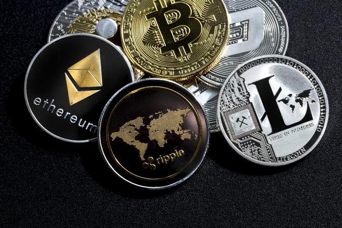 izmir, Turkey - September 28, 2018 Close up ethereum ripple litecoin bitcoin dash coins shot in metallic black background in studio.