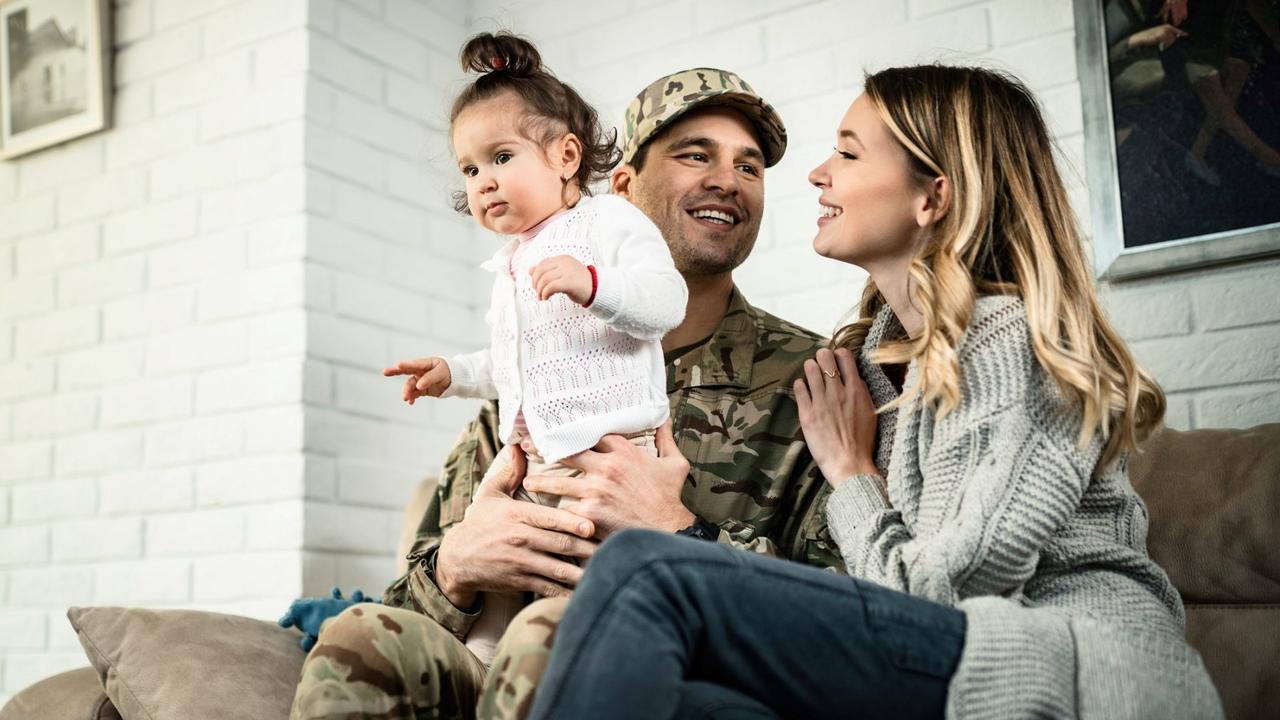 Low angle view of happy military family relaxing at home.