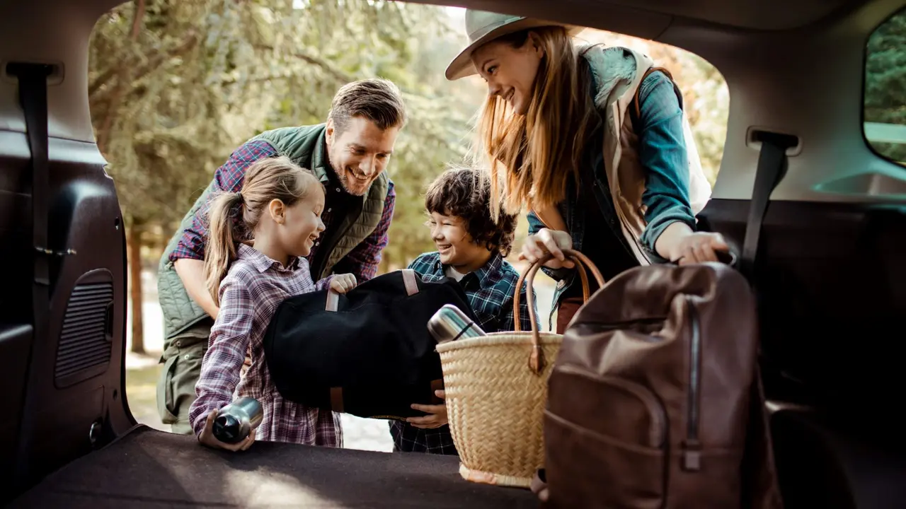 Close up of a young family packing up for a road trip.