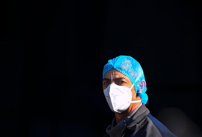 Mandatory Credit: Photo by GEORGI LICOVSKI/EPA-EFE/Shutterstock (11745943a)A woman wearing a protective mask and a hairnet walks in front of the University Clinic for Infectious Diseases in Skopje, Republic of North Macedonia, 04 February 2021.