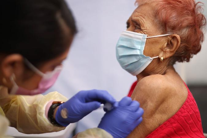Mandatory Credit: Photo by Dania Maxwell/Los Angeles Times/Shutterstock (11759695k)Evelin Nunez, left, gives Concepcion Ponez the Pfizer vaccine during an event to inoculate about 500 health care workers and adults over the age of 65 against COVID-19 put on by the Labor Community Services, the Los Angeles Federation of Labor and St.