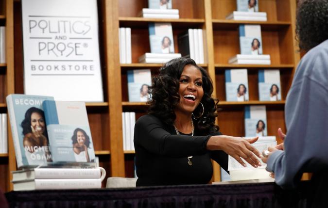 Mandatory Credit: Photo by Jacquelyn Martin/AP/Shutterstock (10479222a)Former first lady Michelle Obama greets people as they buy signed copies of her book, "Becoming,", at Politics and Prose Bookstore in WashingtonMichelle Obama, Washington, USA - 18 Nov 2019.