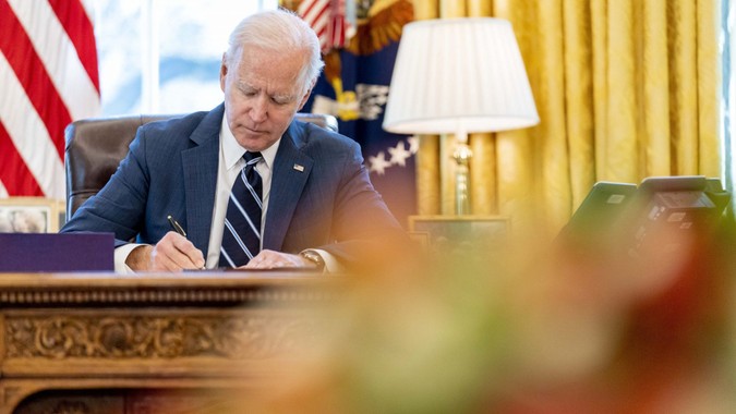 Mandatory Credit: Photo by Andrew Harnik/AP/Shutterstock (11796135c)President Joe Biden signs the American Rescue Plan, a coronavirus relief package, in the Oval Office of the White House, in WashingtonBiden, Washington, United States - 11 Mar 2021.