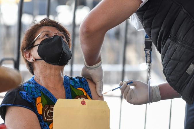 Mandatory Credit: Photo by Eyepix/NurPhoto/Shutterstock (11835979c)A health worker apply a dose of Covid-19 Pfizer-BioNTech during a mass vaccination program to immunize Elderlies more that 60 years of age at Toluca Technological Institute.