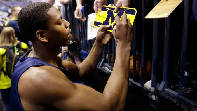 Mandatory Credit: Photo by Michael Conroy/AP/Shutterstock (6195541a)Glenn Robinson III Michigan's Glenn Robinson III signs autographs after practice for the NCAA Midwest Regional semifinal college basketball tournament game, in Indianapolis.
