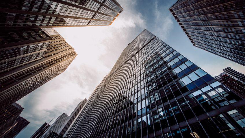 highrise buildings at Wall Street financial district in New York City from below.