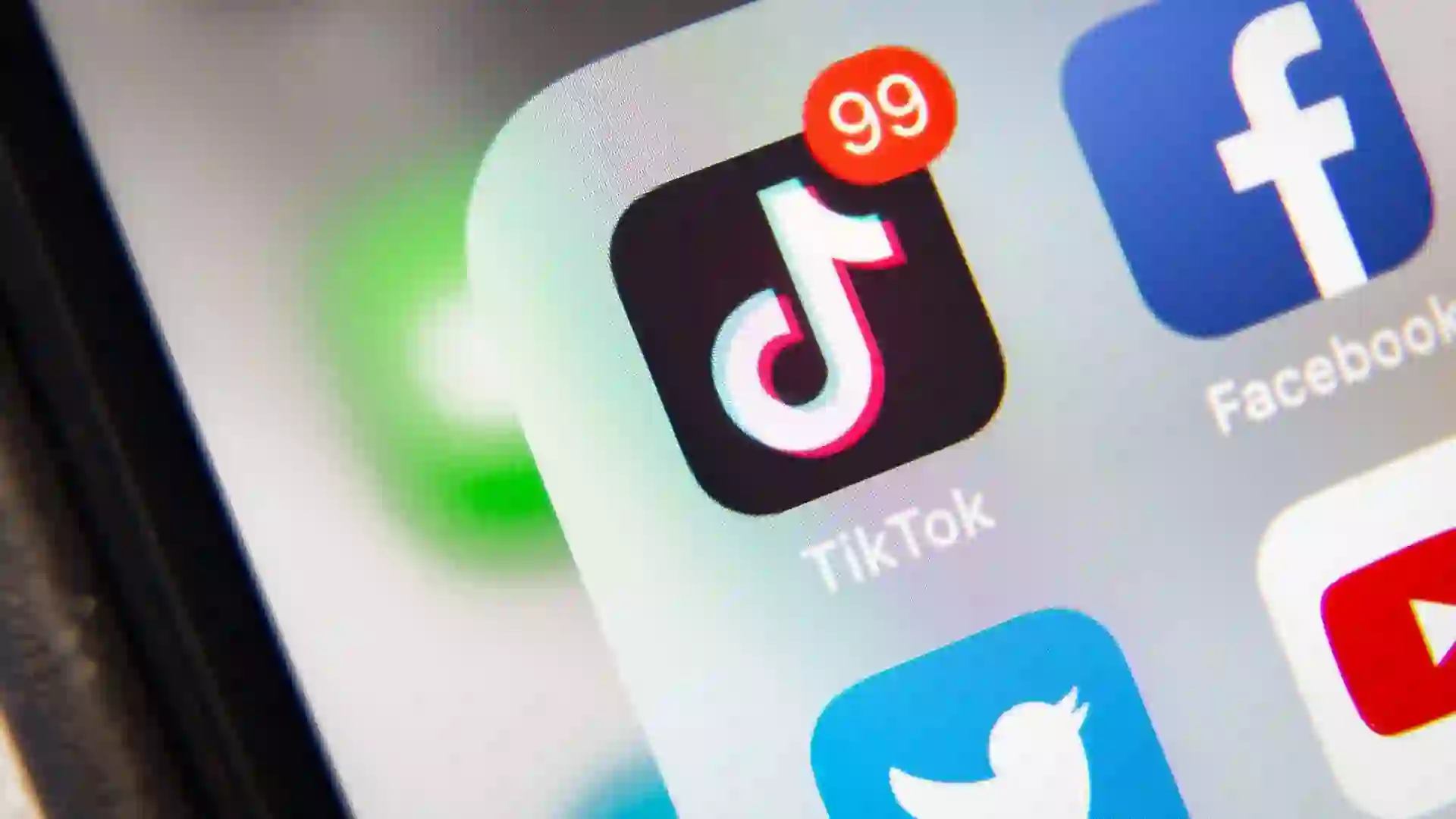 Social media apps including TikTok, Facebook, Twitter (now X) and YouTube displayed on a smartphone.