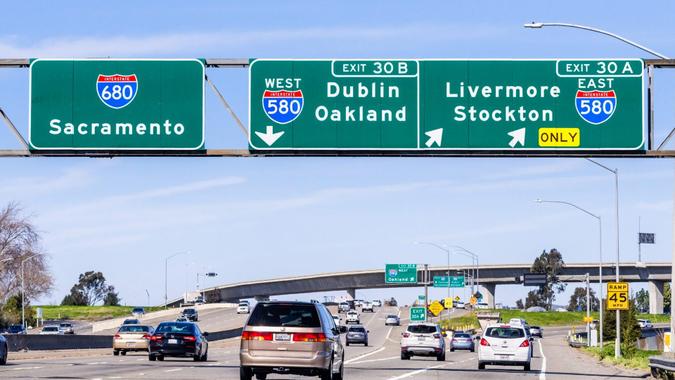 Feb 17, 2020 Pleasanton / CA / USA - Freeway interchange in East San Francisco Bay Area; Signs towards Sacramento, Oakland, Stockton and other destinations, guiding drivers in choosing the right lane.