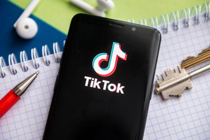 Mandatory Credit: Photo by Mateusz Slodkowski/SOPA Images/Shutterstock (11752883o)In this photo illustration, a TikTok logo seen displayed on a smartphone with a pen, key, book and headsets in the background.