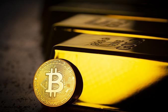 Gold bars and Bitcoin cryptocurrency financial concept.