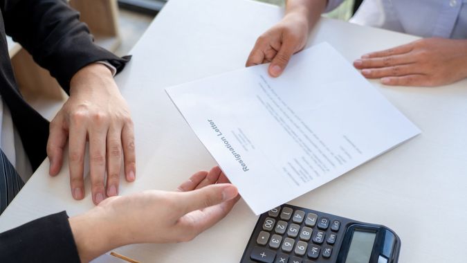 Businessman sending a resignation letter to the executive employer boss on desk, Change of job, unemployment, resign from work concept.