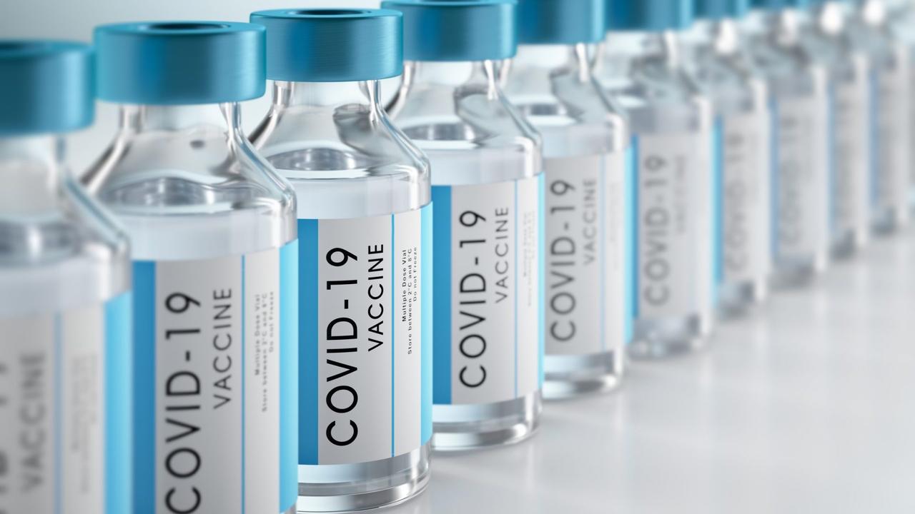 Row Covid-19 or Coronavirus vaccine flasks on white background.