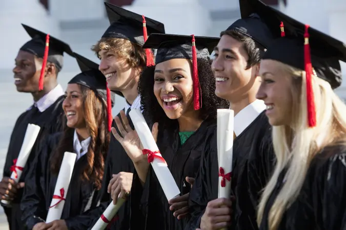 Multi-ethnic friends graduating together, in cap and gown.