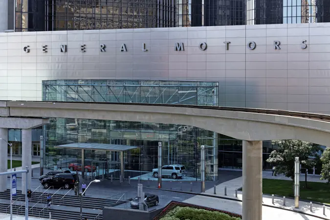 Detroit, MI, USA – July 31, 2014: People exit the General Motors World Headquarters building located in Detroit, Michigan.