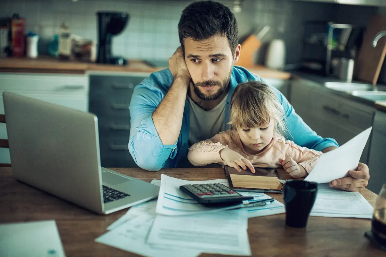 Close up of a father and daughter in their kitchen.