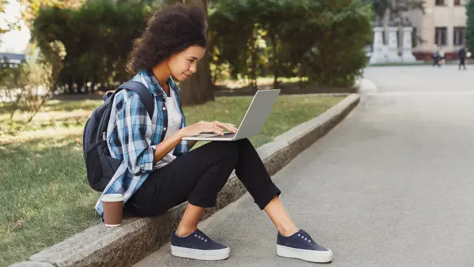 Young woman using laptop at university stock photo