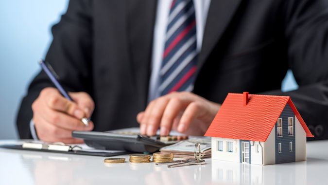 Businessman signs the contract. Purchase agreement for new house. Home ownership concept. stock photo