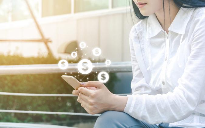 Asian woman hand using mobile phone with online transaction application, Concept financial technology (fintech).