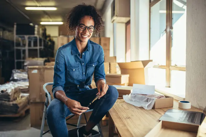 Smiling young woman sitting at her workplace.