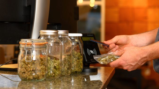Paying by credit card for marijuana at a cannabis dispensary.