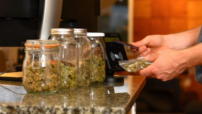 Paying by credit card for marijuana at a cannabis dispensary.