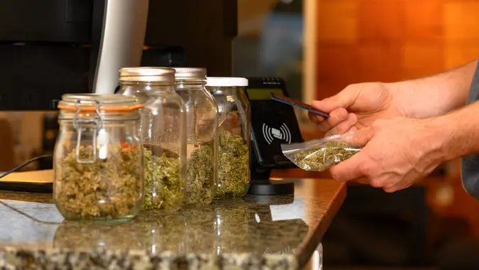 Paying by credit card for marijuana at a cannabis dispensary.
