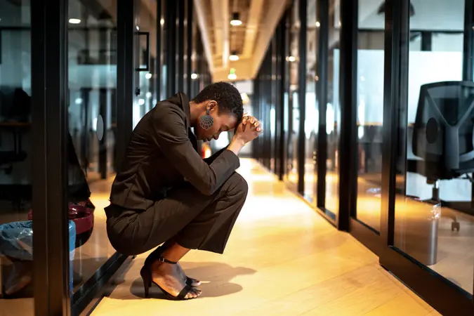 Worried young businesswoman at corridor office.