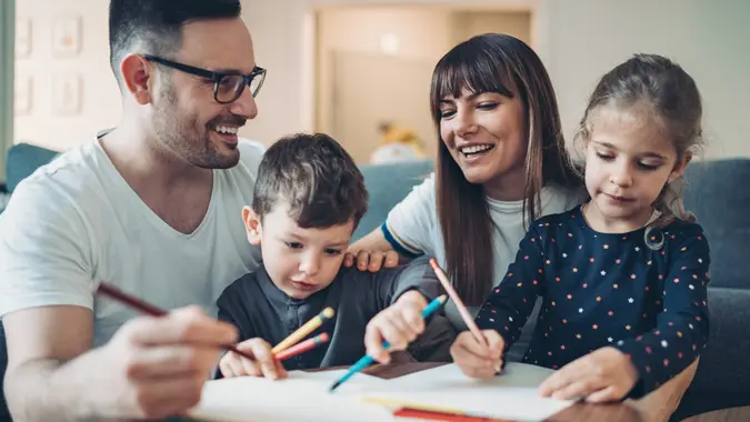 Parents spend time with their children in the living room.