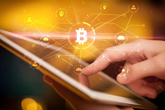 Hand using tablet with cryptocurrency bitcoin link network and online concept.