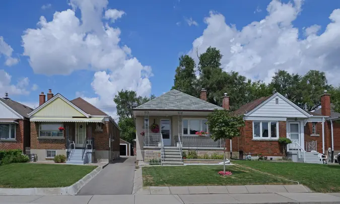 Toronto, Canada- August 17, 2020:  Street with row of modest 1950s style working class bungalows.