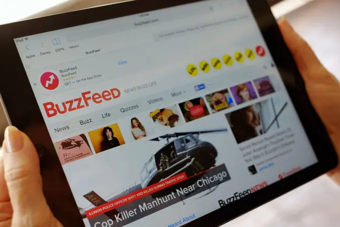 Mandatory Credit: Photo by Richard Vogel/AP/Shutterstock (6087012a)Buzzfeed The BuzzFeed website is displayed on an iPad held by an Associated Press staffer in Los Angeles, on .