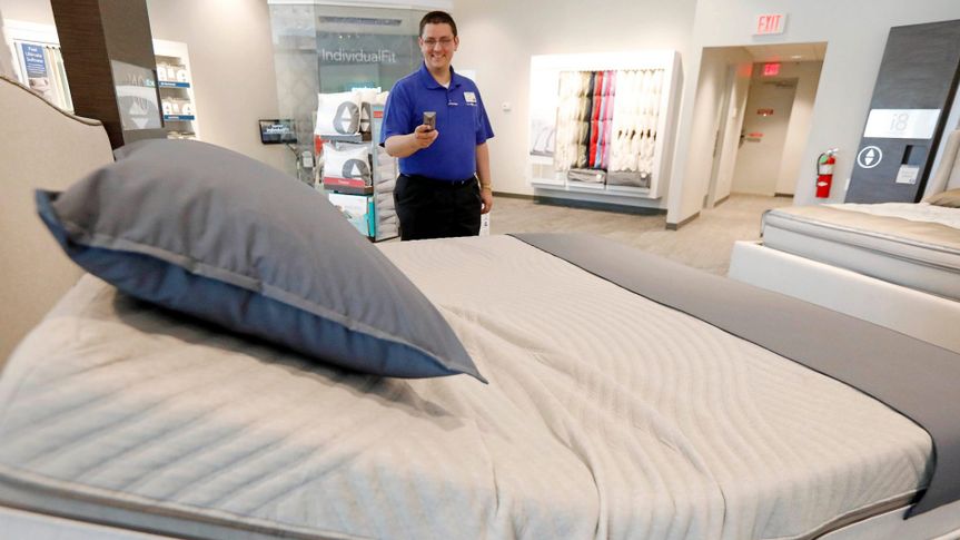 Mandatory Credit: Photo by AP/Shutterstock (8924685b)John Yelverton demonstrates the sleep technology that not only tracks your sleeping patterns, but works in concert with a number of features of the Sleep Number 360 Smart Bed, including a foot warming element, adjustable side comfort, head and foot raising capability and an analysis of how well a person slept.
