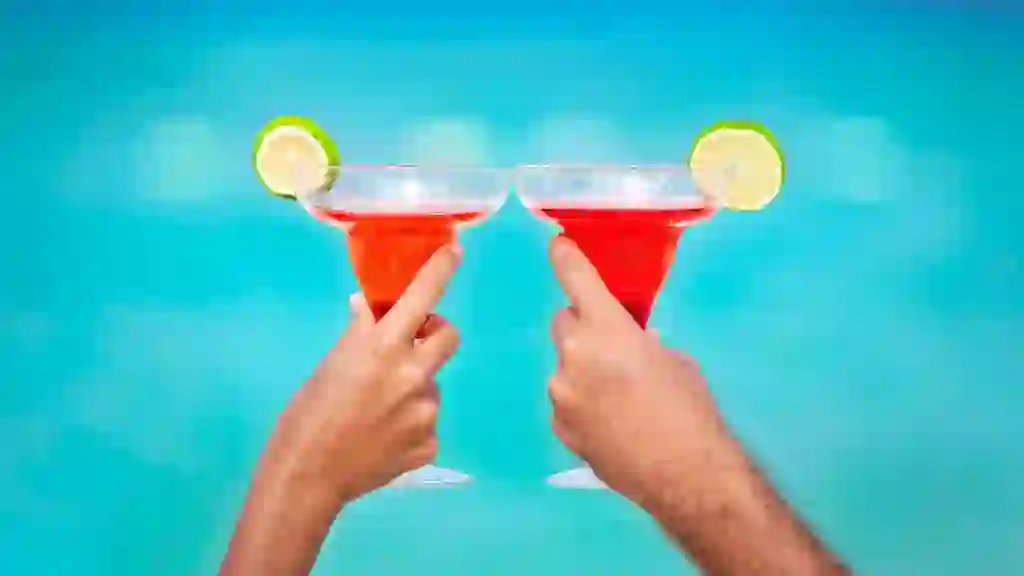 Toasting with Margarita glasses and tropical drinks stock photo