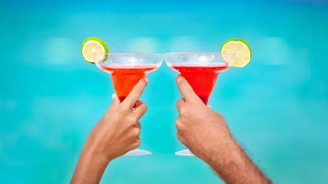 Toasting with Margarita glasses and tropical drinks stock photo