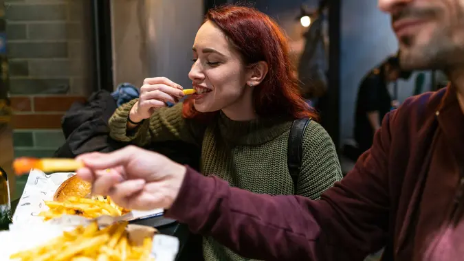 Hungry couple in fast food restaurant stock photo
