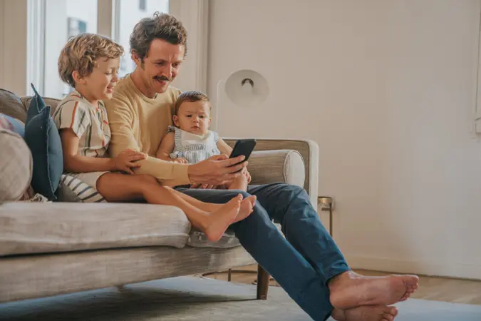 Father using cellphone with children.