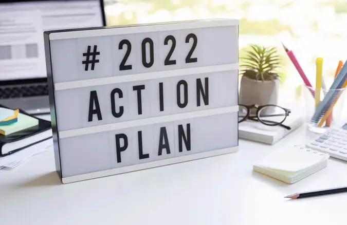 2022 action plan text on light box on desk table in office.