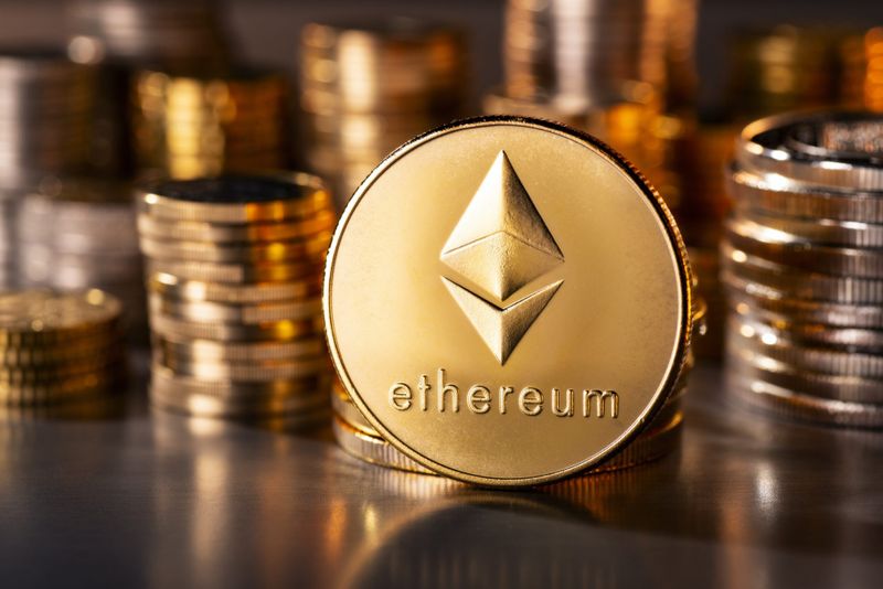 Frankfurt, Hesse, Germany - April 12, 2018: Cryptocurrency coin Ethereum with several stacks of coins in the background.