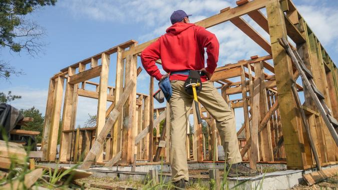 Roofer ,carpenter working on roof structure at construction site stock photo