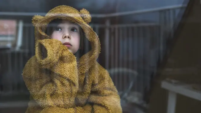 Sad child in isolation at home stock photo