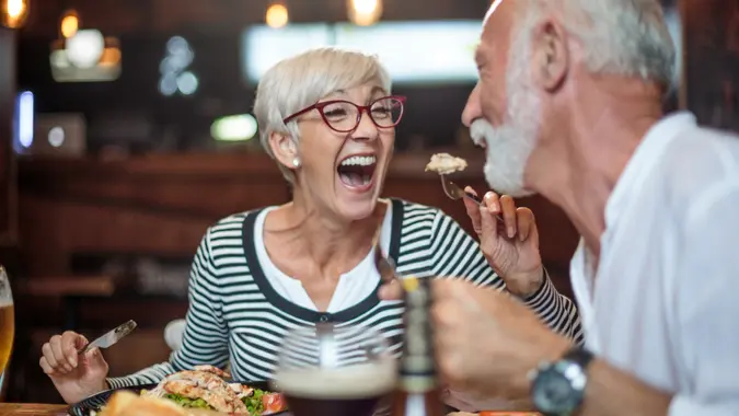 Woman and man laughing during dinner