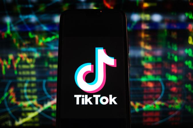 Mandatory Credit: Photo by Omar Marques/SOPA Images/Shutterstock (11876645al)In this photo illustration a TikTok logo is displayed on a smartphone with stock market percentages in the background.