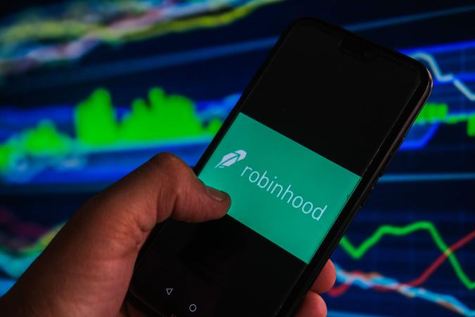 Mandatory Credit: Photo by Omar Marques/SOPA Images/Shutterstock (12007968r)In this photo illustration a Robinhood logo is displayed on a smartphone with stock market percentages in the background.
