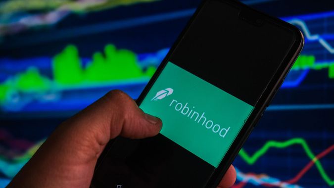 Mandatory Credit: Photo by Omar Marques/SOPA Images/Shutterstock (12007968r)In this photo illustration a Robinhood logo is displayed on a smartphone with stock market percentages in the background.