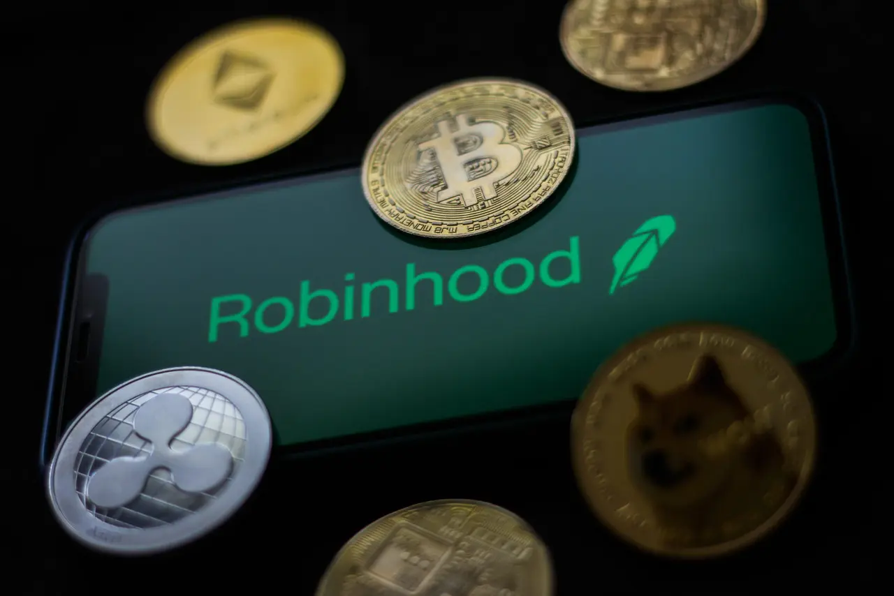 Mandatory Credit: Photo by Jakub Porzycki/NurPhoto/Shutterstock (12190038b)Robinhood logo displayed on a phone screen and representation of cryptocurrencies are seen in this illustration photo taken in Krakow, PolandRobinhood and Cryptocurrencies photo illustrations, Krakow, Poland - 29 Jun 2021.