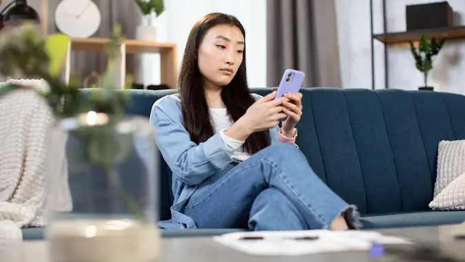 Asian woman having video call on smartphone stock photo