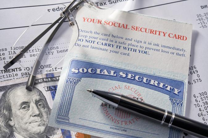 Social Security Card with calculator and money.
