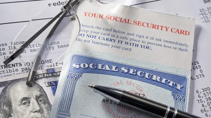 Social Security Card with calculator and money.
