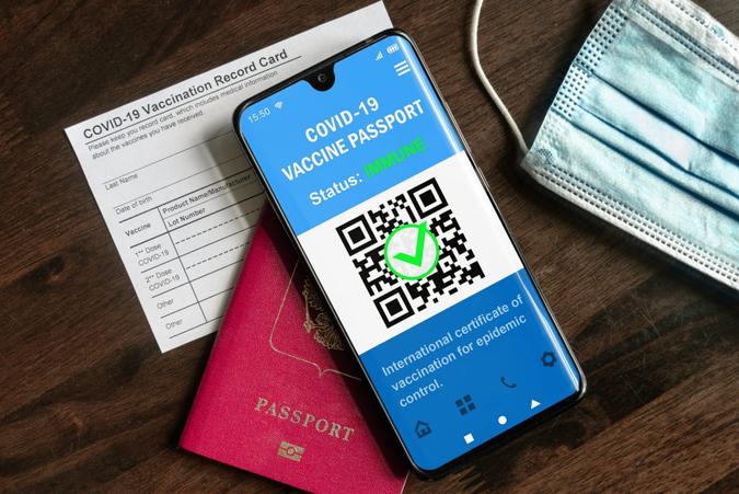 Health passport of COVID-19 vaccination in mobile phone for travel, digital passport app in smartphone.